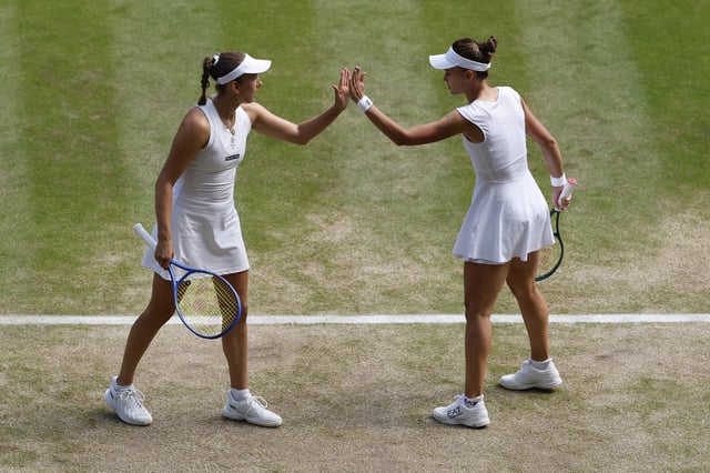 Tennis - Wimbledon - All England Lawn Tennis and Croquet Club, London, Britain - July 13, 2025 Russia's Veronika Kudermetova and Belgium's Elise Mertens react during their women's doubles final match against Latvia's Jelena Ostapenko and Taiwan's Hsieh Su-wei REUTERS/Stephanie Lecocq