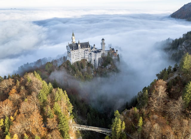 Mist surrounds the Neuschwanstein Castle on October 31, 2024, in Hohenschwangau, Germany.