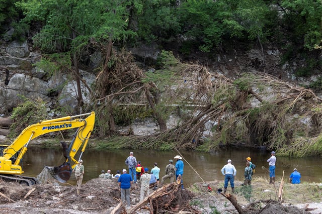 Members of a search and rescue team look for missing people amid debris in the waters of the Guadalupe River, near Camp Mystic, following deadly flooding, ahead of U.S. President Donald Trump's travel to Texas to tour areas affected by deadly flash flooding, in Hunt, Texas, U.S., July 11, 2025. REUTERS/Umit Bektas/File Photo