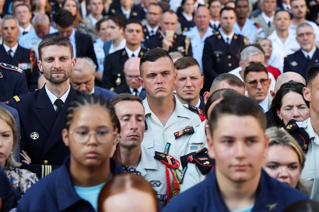 Members of the French military listen to the French President Emmanuel Macron's (not pictured) address,