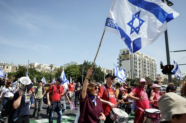 People march a rally against recent moves by the Israeli government to fire the Attorney General Gali Baharav Miara and the dismissal of top security agency chief, Ronen Bar, as well as the demand to release all hostages, in Tel Aviv, Israel March 26, 2025. REUTERS/Nir Elias/File Photo