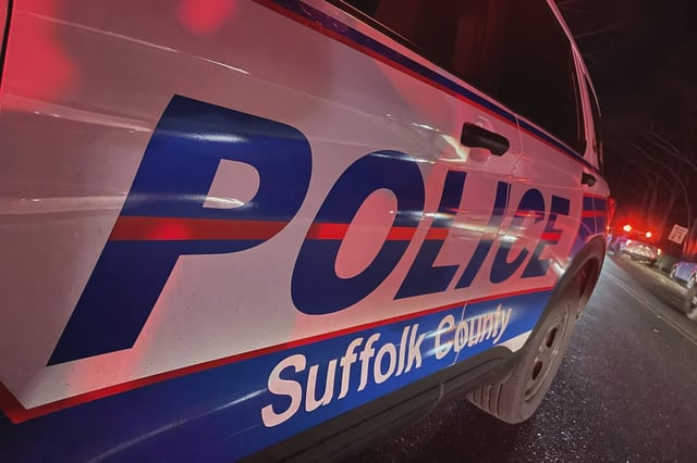 Police on Long Island say an officer shot and killed a man who tried to stab someone already being treated for a neck wound.