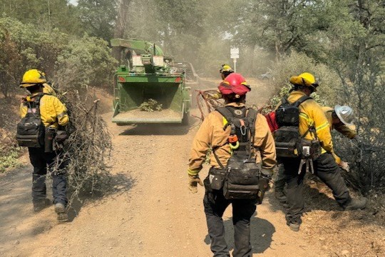 Members of the Colusa, Maxwell and Willows Rural fire departments, in partnership with Cal Fire, widen roads on Backbone Road south of the Green Fire in Shasta County. 