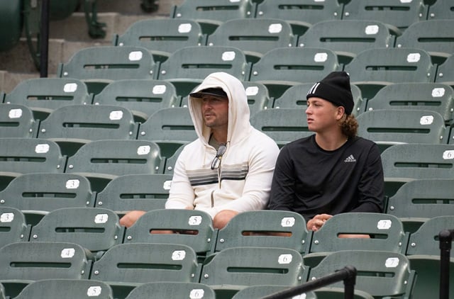 Orioles Jackson Holliday, father Matt and brother Ethan watch him during batting practice at Camden Yards. (Kevin Richardson/Staff)