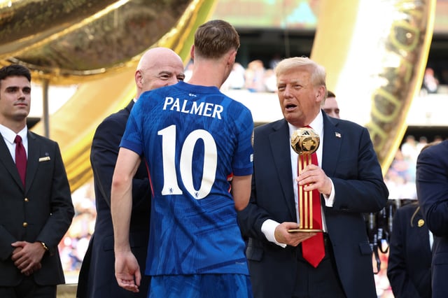 U.S. President Donald Trump presents Chelsea's Cole Palmer with the golden ball trophy next to FIFA president Gianni Infantino after Chelsea won against Paris St Germain in the FIFA Club World Cup final, at the MetLife Stadium in East Rutherford, New Jersey, U.S., July 13, 2025. REUTERS/Kevin Lamarque/Pool