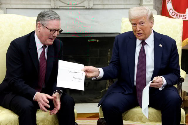 U.S. President Donald Trump holds a letter from Britain's King Charles as he meets with British Prime Minister Keir Starmer in the Oval Office at the White House in Washington, D.C., U.S., February 27, 2025. REUTERS/Kevin Lamarque/File Photo