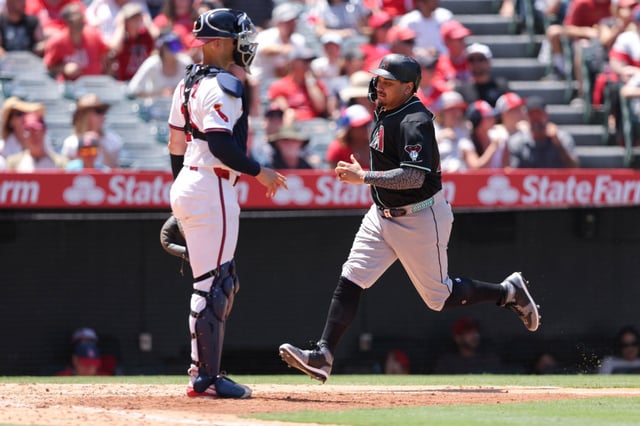 Arizona’s Josh Naylor scores as Angels catcher Logan O’Hoppe watches during the fourth inning of a baseball game in Anaheim, Calif., Sunday, July 13, 2025. (AP Photo/Jessie Alcheh)