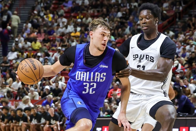 Cooper Flagg #32 of the Dallas Mavericks drives against Nathan Mensah #31 of the San Antonio Spurs in the second half of a 2025 NBA Summer League game at the Thomas &amp; Mack Center on July 12, 2025 in Las Vegas, Nevada.