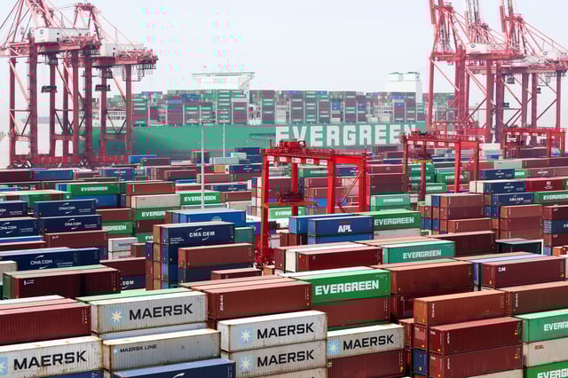 Gantry cranes stand near shipping containers as an Evergreen Marine Corp container ship, Ever Ace, is docked at Yangshan Port outside of Shanghai, China, June 17, 2025.  REUTERS/Go Nakamura/File Photo