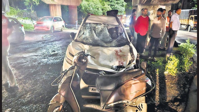 Mangled remains of the car and scooter that was striken by pipes