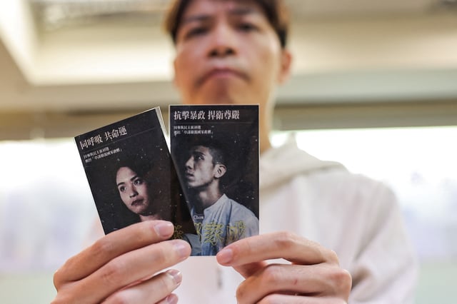 Sky Fung, Secretary-General, Hong Kong Outlanders, holds cards showing pictures of activists Owen Chow and Gwyneth Ho during a press conference in Taipei, Taiwan November 20, 2024. REUTERS/Ann Wang/File photo