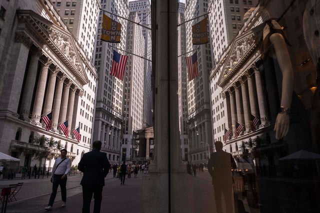 A reflection of a window shows the New York Stock Exchange on Monday, June 30, 2025, in New York. (AP Photo/Yuki Iwamura)