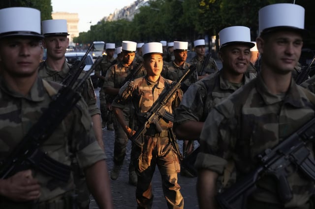 Foreign Legion soldiers arrive for a rehearsal for the upcoming Bastille Day parade, Wednesday, July 9, 2025 on the Champs-Elysees avenue in Paris. (AP Photo/Michel Euler)