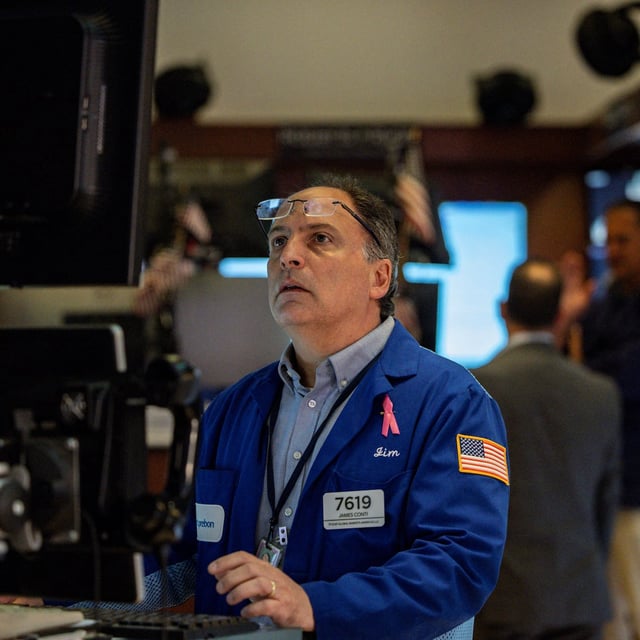 FILE PHOTO: A trader works on the floor at the New York Stock Exchange (NYSE) in New York City, U.S., July 11, 2025. REUTERS/Jeenah Moon/File Photo