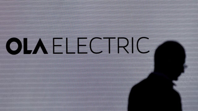 A man walks past the logo of Ola Electric during a press conference ahead of it's IPO launch in Mumbai, India, July 29, 2024. 