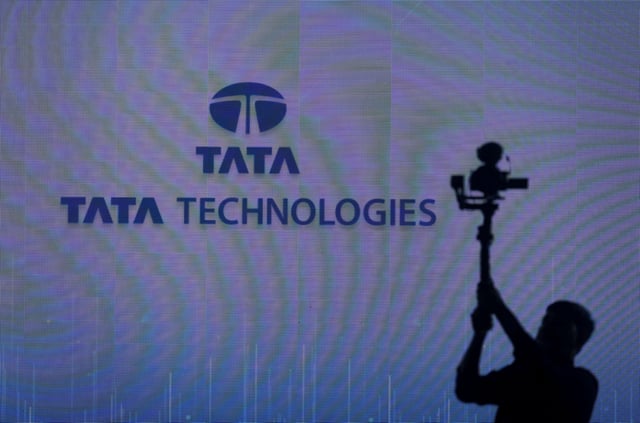A cameraman works in front of the Tata Technologies logo during a press conference announcing a joint venture between Tata Technologies and BMW Group, in Mumbai, India, October 8, 2024. REUTERS/Francis Mascarenhas/File Photo