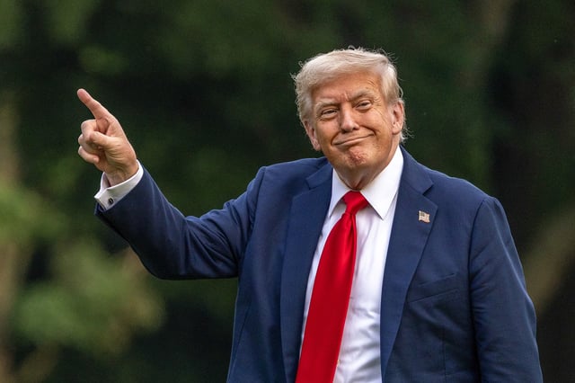 U.S. President Donald Trump walks on the south lawn of the White House and points up at the new flag on July 13, 2025 in Washington, DC.
