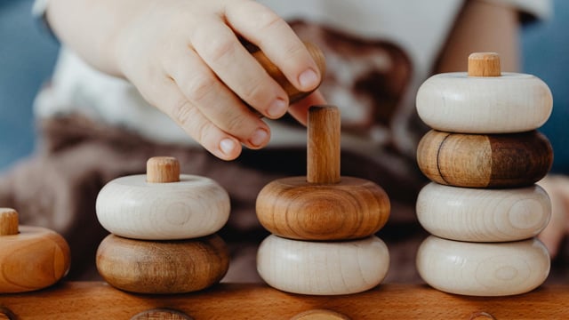 An image of a child playing with wooden blocks. Image: Pexels