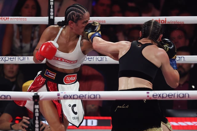 Jul 11, 2025; New York, New York, UNITED STATES; Amanda Serrano (red gloves) and Katie Taylor (blue gloves) fight during the undisputed super lightweight championship boxing bout at Madison Square Garden. Mandatory Credit: Vincent Carchietta-Imagn Images