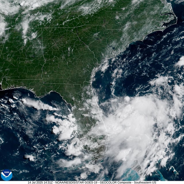 The National Hurricane Center is monitoring a system of low atmospheric pressure, seen as a cluster of clouds Monday morning in this weather satellite photo of Florida&#39;s Atlantic coast. Forecasters are watching for potential tropical development as the low pressure system moves into the northeastern Gulf of Mexico through Tuesday.