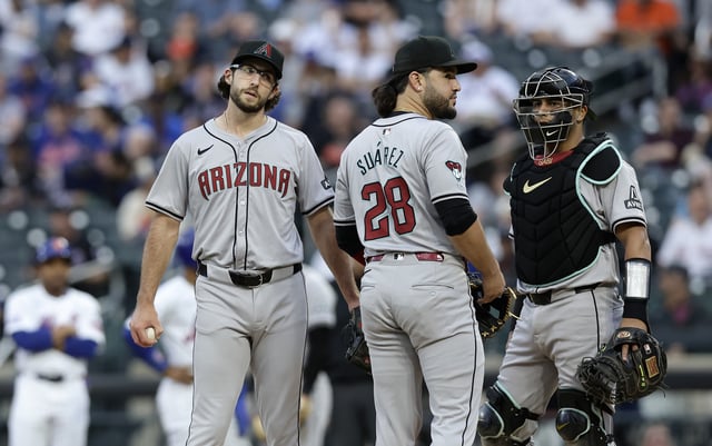 NEW YORK, NEW YORK - MAY 30: Zac Gallen #23 of the Arizona Diamondbacks looks on from the mound with teammates Eugenio Suarez #28 and catcher Gabriel Moreno #14 prior to leaving a game against the New York Mets in the first inning at Citi Field on May 30, 2024 in New York City.