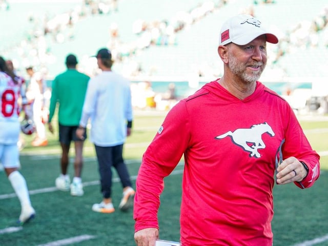 Calgary Stampeders head coach Dave Dickenson walks on the field after CFL football action against the Saskatchewan Roughriders in Regina, on Saturday, July 12, 2025.