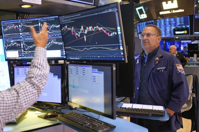 Anthony Matesic works on the floor at the New York Stock Exchange in New York, Monday, July 14, 2025. (AP Photo/Seth Wenig)