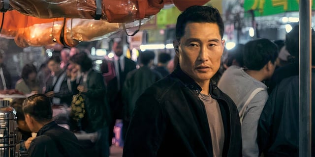 Daniel Dae Kim looking around in a crowded place in Butterfly