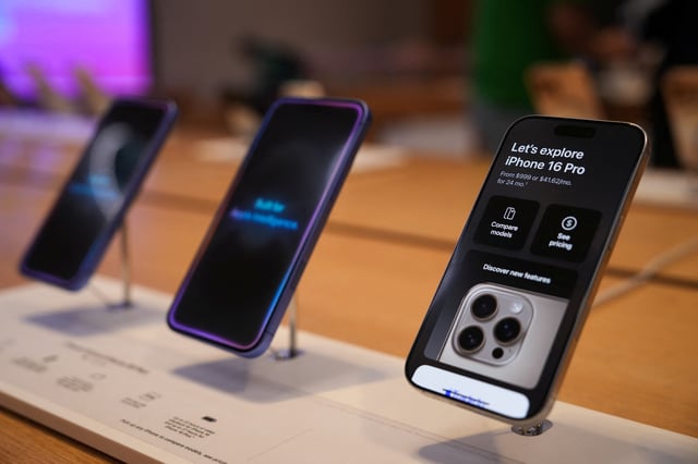iPhones sit on display at the Apple Fifth Avenue store, in New York City, U.S., May 23, 2025. REUTERS/Adam Gray/File Photo