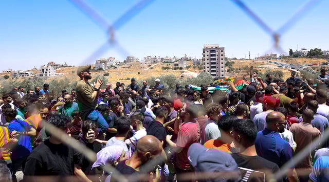 Mourners carry the bodies of Mohammad al-Shalabi, 23, and Sayafollah Musallet, 20, during their funeral on July 13, 2025, in Al-Mazra'a ash-Sharqiya, east of Ramallah in the occupied West Bank. (Mohammad Nazal / Middle East Images via AFP)