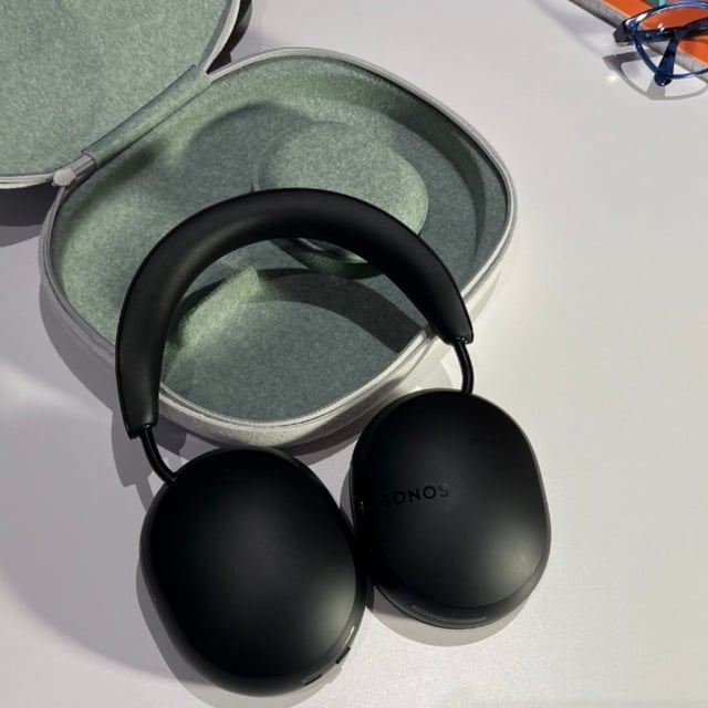 the Sonos Ace headphones laying on a table with their case