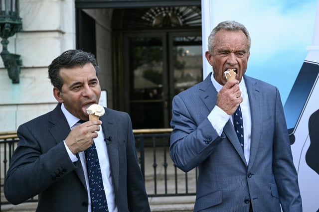 (L/R) Food and Drug Administration Commissioner (FDA) Martin Makary and Secretary of Health and Human Services Robert F. Kennedy Jr., eat ice cream at the end of a news conference at the USDA headquarters building in Washington, DC, on July 14, 2025