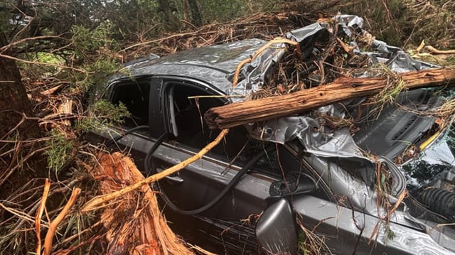 Two people were rescued when their vehicle was swept a mile downstream during Texas flooding, authorities say.