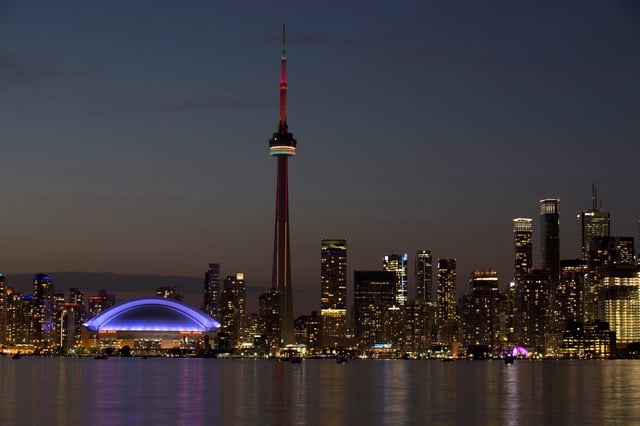FILE - In this July 26, 2015 file photo, the sun sets over the CN Tower and Rogers Centre during the closing ceremonies of the Pan Am Games in Toronto. Toronto’s attractions are getting an extra dose of attention because the city is hosting the 2016 NBA All-Star game. 