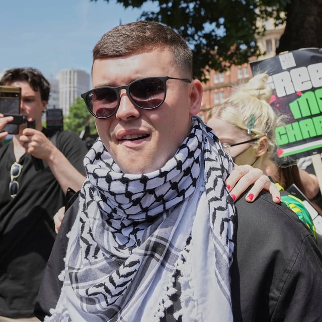 Liam Óg Ó hAnnaidh, aka Mo Chara, a member of the Irish language band Kneecap, leaves Westminster Magistrates Court London, Wednesday, June 18, 2025, where he is charged with a terrorism offence relating to displaying a flag in support of Hezbollah during a performance with the band in November 2024. (AP Photo/Kin Cheung)