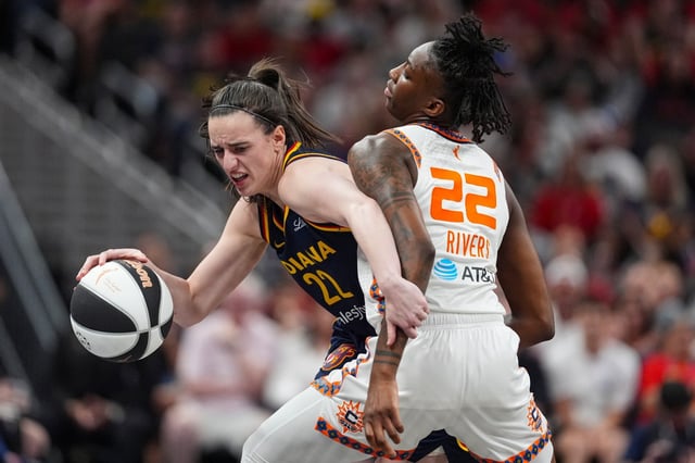Indiana Fever guard Caitlin Clark (22) tries to get past Connecticut Sun guard Saniya Rivers (22) in the second half of a WNBA basketball game in Indianapolis, Tuesday, June 17, 2025. (AP Photo/Michael Conroy)