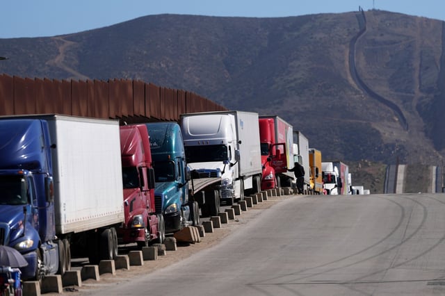 Commercial trucks line up to cross the border into the United States on March 4, 2025, in Tijuana, Mexico. (AP Photo/Gregory Bull)