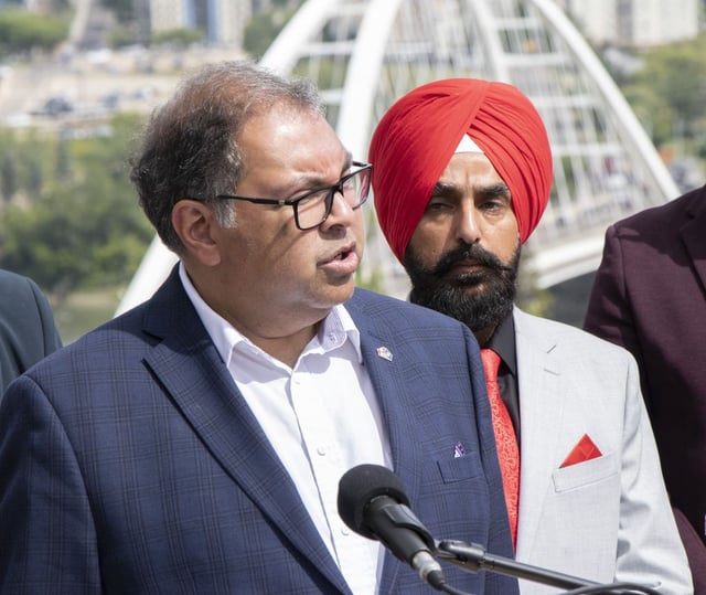 MLA Gurtej Singh Brar stands behind NDP Leader Naheed Nenshi on Monday, July 14, 2025, in Edmonton. The Alberta NDP is launching a province-wide caucus initiative to connect with Albertans and stand up for Canada. 