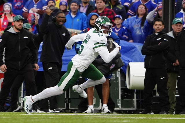 Dec 29, 2024; Orchard Park, New York, USA; New York Jets wide receiver Garrett Wilson (5) runs with the ball after making a catch against the Buffalo Bills during the first half at Highmark Stadium. Mandatory Credit: Gregory Fisher-Imagn Images/File Photo