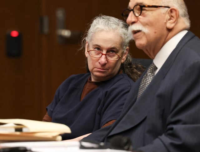 Sitting next to her attorney, Jed Stone, Marni Yang reacts after learning her conviction hearing will be delayed at the Lake County Courthouse on July 14, 2025, in Waukegan. Yang was convicted in 2011 for the murder of Rhoni Reuter and her unborn baby. (Stacey Wescott/Chicago Tribune)
