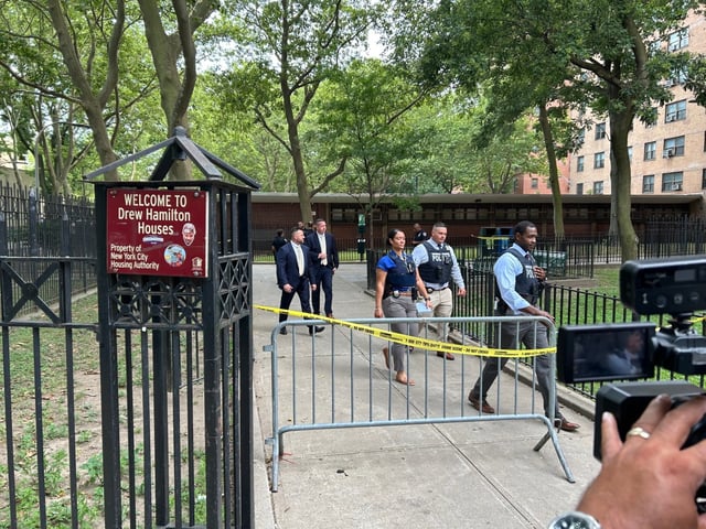 NYPD investigate the scene where an unidentified 30-year-old male was shot in the abdomen and left arm and a 40-year-old woman was grazed in the lower back in the rear of NYCHA’s Drew Hamilton Houses on Frederick Douglass Blvd. on July 14, 2025. (Kerry Burke/New York Daily News)