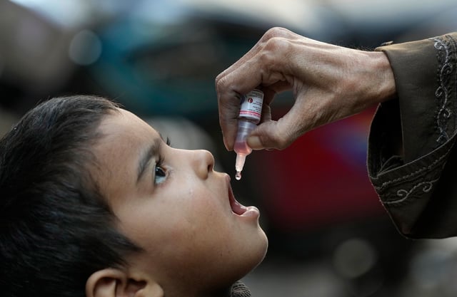 A health worker administers a polio vaccine to a child in Karachi, Pakistan, on January 8, 2024.