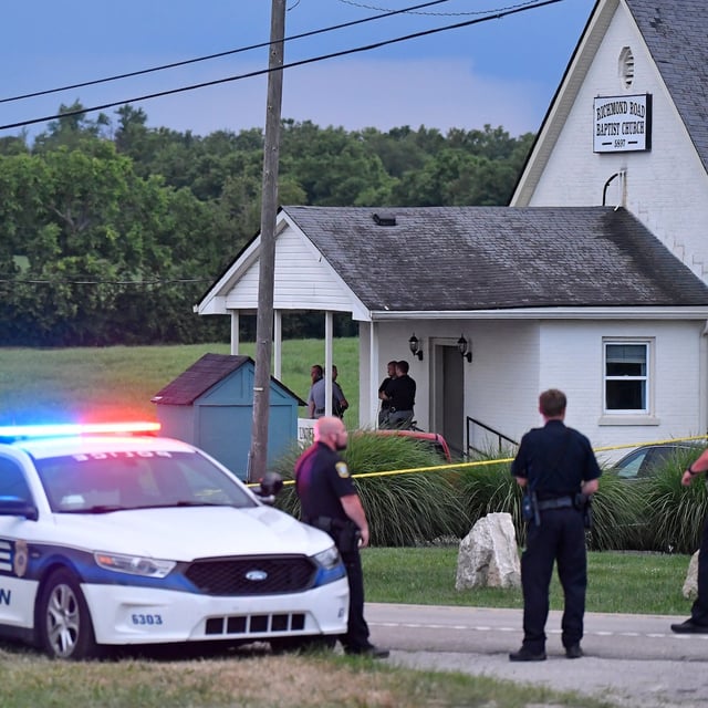 Police stand at the front of the Richmond Road Baptist Church as other officers maintain a perimeter following a shooting at the church in Lexington, Ky., Sunday, July 13, 2025. (AP Photo/Timothy D. Easley)