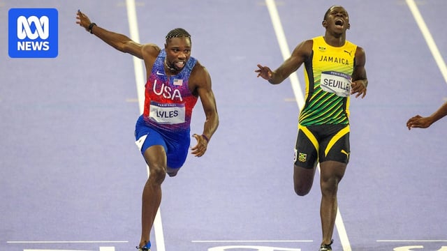 American sprinter Noah Lyles dips over the finish line to win the men's 100m Olympic final, with a Jamaican runner behind him.