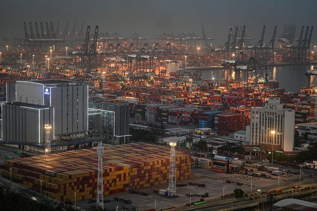 Shipping containers and gantry cranes are seen at the Yantian port at night in Shenzhen, in southern China's Guangdong province on April 14, 2025. Markets on April 14 welcomed a US tariffs reprieve for electronics, but President Donald Trump warned no country would get "off the hook" in his trade war -- especially China. (Photo by JADE GAO / AFP) (Photo by JADE GAO/AFP via Getty Images)          