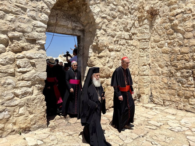 Le patriarche orthodoxe de Jérusalem, Théophile III (à gauche), et le cardinal catholique Pizzaballa (à droite) entrent dans l’église Saint-Georges, à Taybeh, en Cisjordanie, pour entamer une prière.