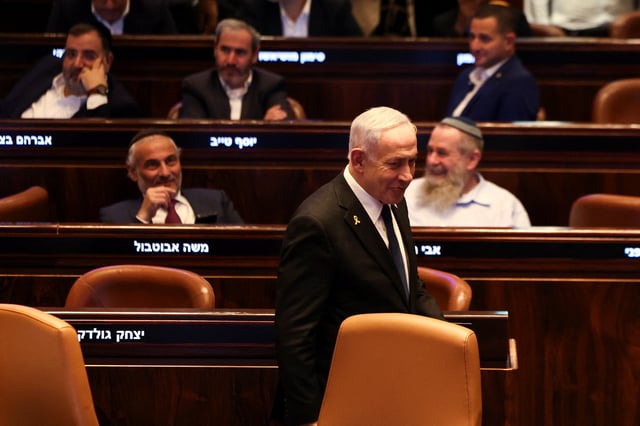 Israeli Prime Minister Benjamin Netanyahu walks in the Knesset, Israel's parliament, on the day of a vote over a possible expulsion of Ayman Odeh from parliament, in Jerusalem, July 14, 2025. REUTERS/Ronen Zvulun