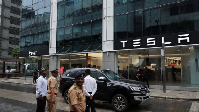 Police officers directed traffic outside the Tesla showroom ahead of its opening in Mumbai on Tuesday.