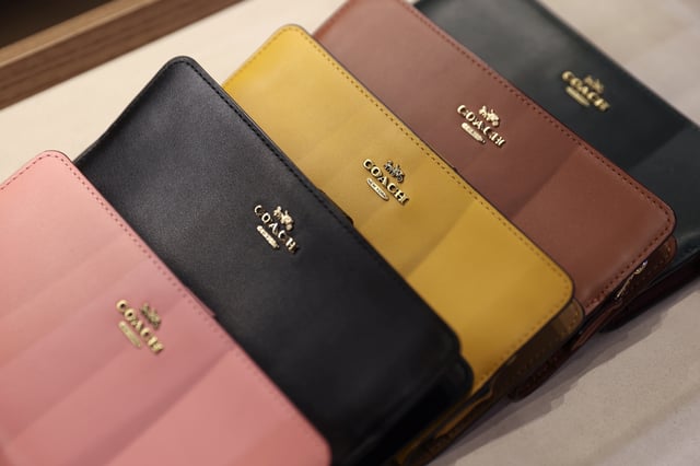Products are seen in a Coach store, a brand owned by Tapestry, Inc., in Manhattan, New York, U.S., November 15, 2021. REUTERS/Andrew Kelly/File Photo
