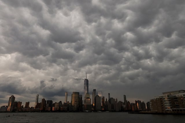 A group of mammatus clouds passes over the skyline of lower Manhattan and One World Trade Center as the sun sets in New York City on July 3, 2025, as seen from Jersey City, New Jersey.